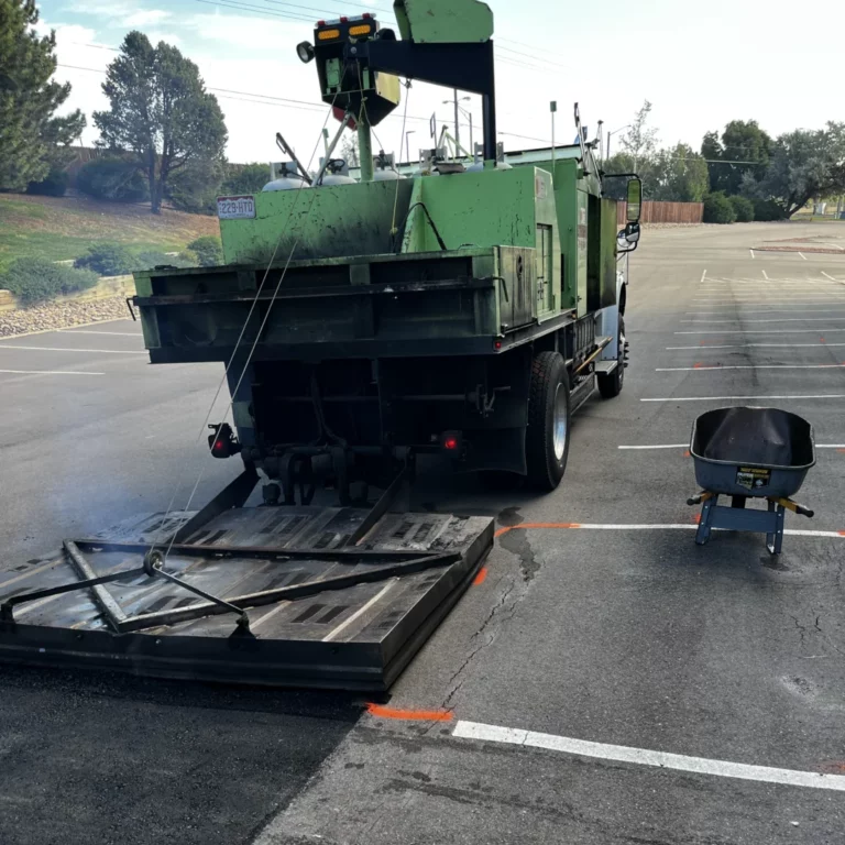 Asphalt Coatings Company patch truck working in a striped parking lot
