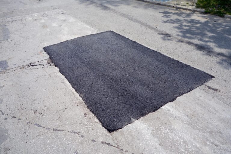 Finished rectangular saw-cut asphalt patch with clean straight edges